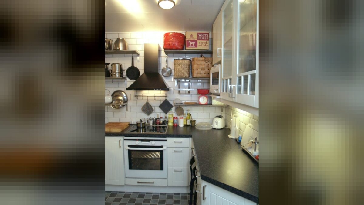 Open-shelved black and white kitchen with subway tiling
