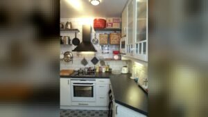 Open-shelved black and white kitchen with subway tiling